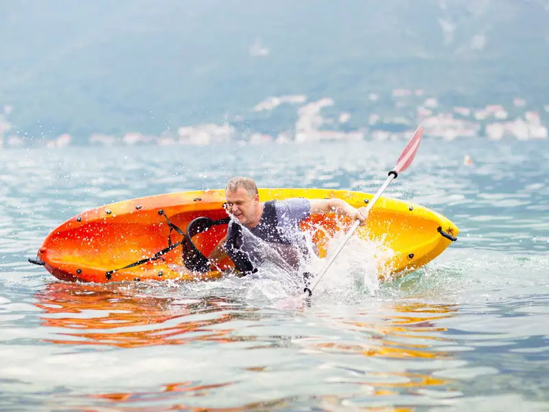 A man fliping a sit on kayak